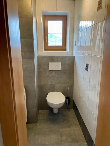 a small bathroom with a toilet and a window at Appartement Natalie in Ried im Zillertal