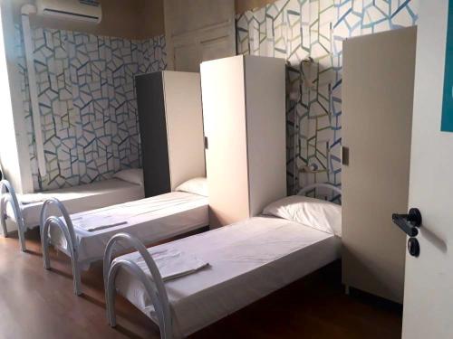 a room with two beds in a room at Balarm - Hostel and Bar in Palermo