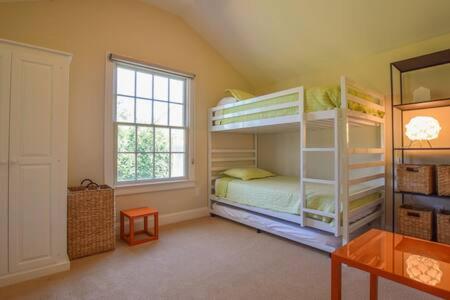 a bedroom with two bunk beds and a window at 1 min drive to Rock Harbor 2 min to Town in Orleans