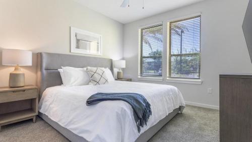 a bedroom with a bed and two windows at Landing Modern Apartment with Amazing Amenities (ID4496) in Jacksonville