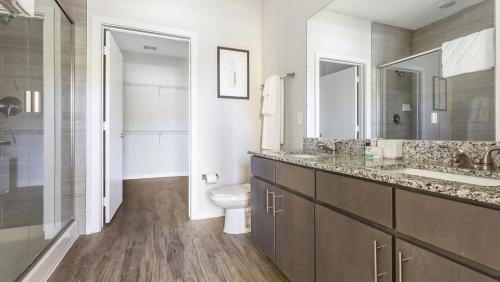 a bathroom with a toilet and a sink and a mirror at Landing Modern Apartment with Amazing Amenities (ID4496) in Jacksonville