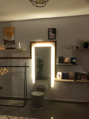 a room with a mirror and a stool and a light at AL DOKI COMFORT ROOM - Males only in Cairo