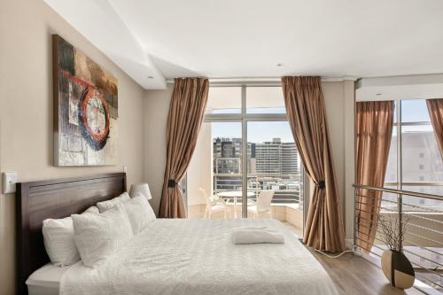 a bedroom with a bed and a large window at Hydro Park Residences in Sandton WITH GENERATOR in Johannesburg