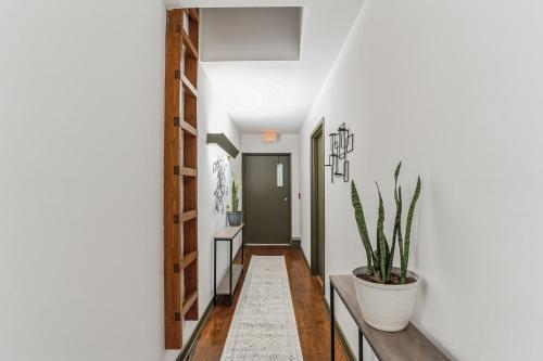 a hallway with white walls and a potted plant at Thornton Studio with Kitchenette in Thornton