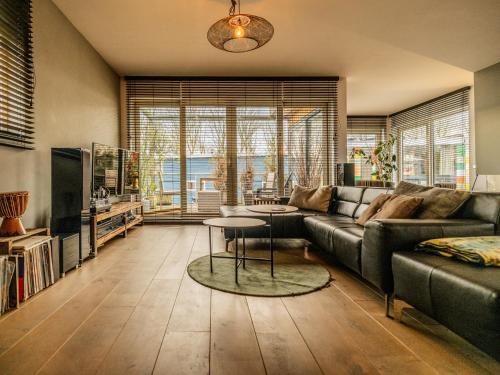 a living room with a couch and a table at NOVA Houseboat DELUXE Free Bikes in Amsterdam
