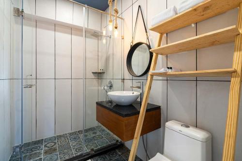 a bathroom with a sink and a mirror and a toilet at Serene By Sunkissed Villa in Kasauli