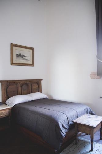 a bedroom with a bed with a table next to it at Casa Eugenia Hotel in Morelia