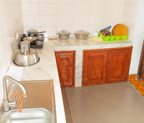 a kitchen with a sink and a counter top at TOKY Hôtel in Antsirabe