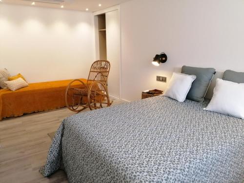 a bedroom with a bed and a chair at Casa de Férias do Parque da Peneda 2 in Vila Verde