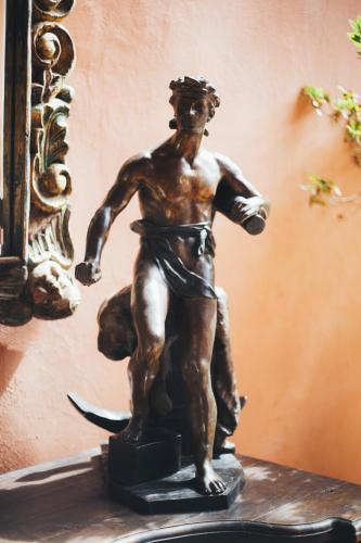 a bronze statue of a man on a shelf at Casa Eugenia Hotel in Morelia