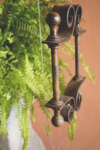 a metal light next to a green plant at Casa Eugenia Hotel in Morelia