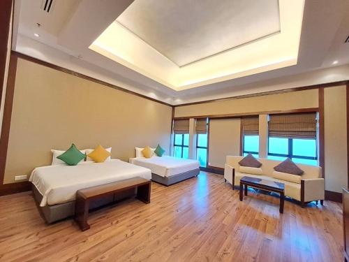a large room with two beds and a couch at The Artz Hotel in Genting Highlands