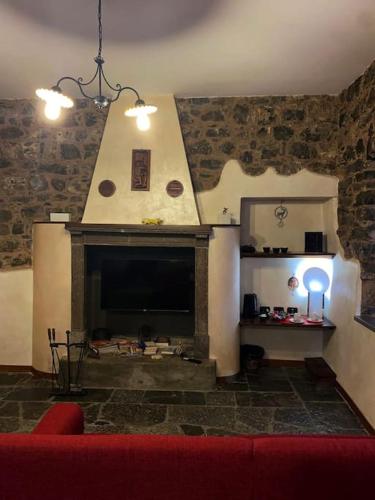 a living room with a fireplace and a red couch at La piccola Corte in Roncola