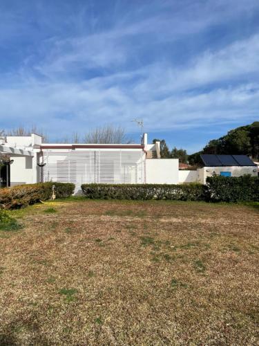 a white building with a yard in front of it at GIGLIO DI MARE Residence in Sellia Marina