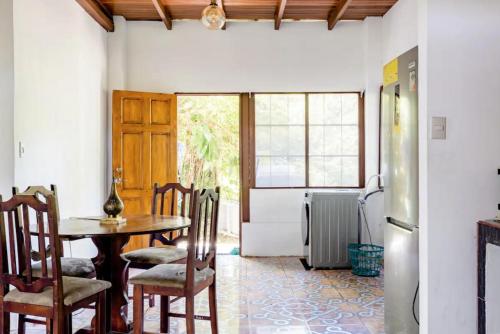 a dining room with a table and chairs at Casa Patricia in Uvita