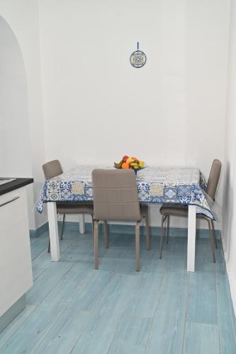 a dining room table with chairs and a table cloth at Vesuvius Dream in Boscotrecase