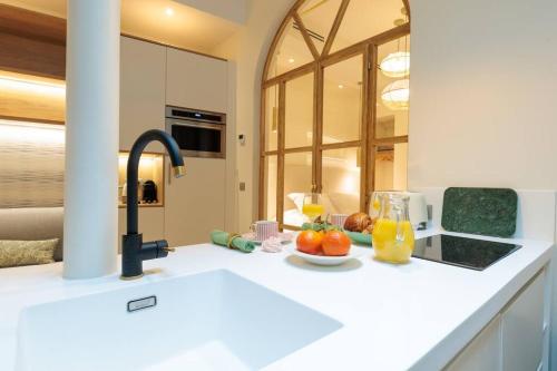 - une cuisine avec un évier et un bol de fruits sur un comptoir dans l'établissement New Luxury and Cozy apartment - Notre Dame, à Paris