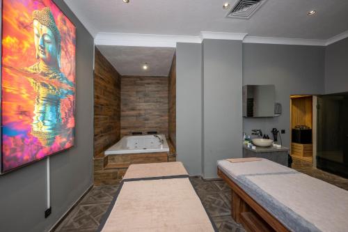 a bathroom with a bath tub and a painting on the wall at The Nirvanas Hotel in Istanbul