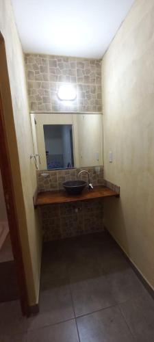 a bathroom with a sink and a mirror at Alemar Termas Hotel in Termas de Río Hondo