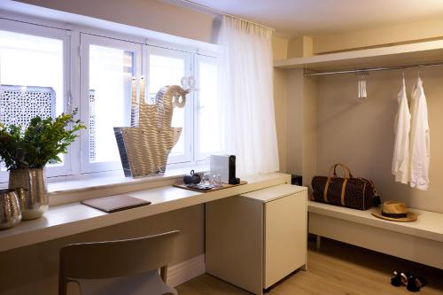 a room with a desk and a window with a computer at Vrachos Athens Suites in Athens