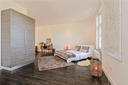 a bedroom with a bed and a large cabinet at Bohemian Residence in Maastricht