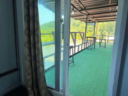 a view of a balcony with a table and chairs at Baan Plai Laem Homestay at Koh Paluay in Koh Phaluai