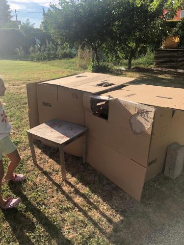 a small child standing next to a box and a bench at B&B MELLONI STREET in Dolo