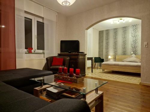 a living room with a couch and a table with red candles at Klaschter Gastewohnung in Groß-Umstadt