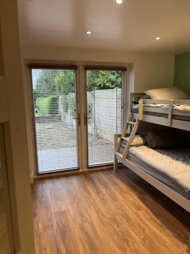 a bedroom with a bunk bed and a sliding glass door at Country Retreat Near Emerald Park in Dunshaughlin