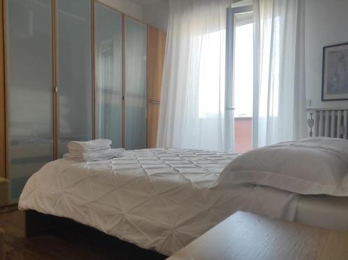 a bedroom with a large bed with towels on it at Appartamento - Rho Centro 6 - in Rho
