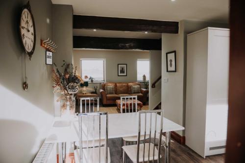 a kitchen and living room with a table and chairs at Pattys Farm Barn in Cockerham