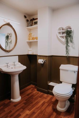 a bathroom with a toilet and a sink at Pattys Barn Holiday Cottages, Cabins and Venue Hire in Cockerham