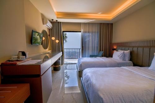a hotel room with two beds and a balcony at The Country Lodge Hotel in Freetown