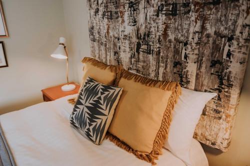 a bedroom with a bed with two pillows on it at Pattys Barn Holiday Cottages, Cabins and Venue Hire in Cockerham