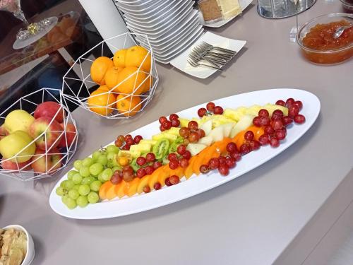 a plate of fruit and vegetables on a table at Hotel Garni Colora in Bad Radkersburg