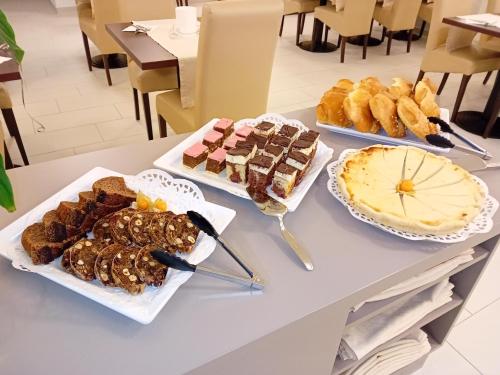 a table with several different types of food on it at Hotel Garni Colora in Bad Radkersburg