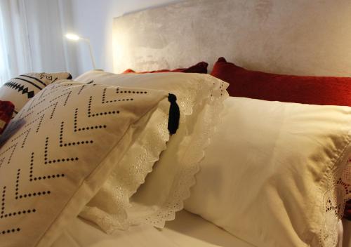 a white bed with white pillows on it at Apartamento Centro de Pontevedra in Pontevedra