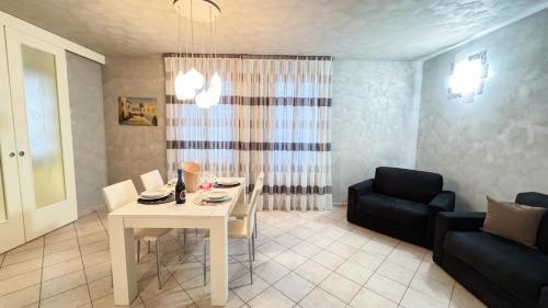 a living room with a table and a couch at Lady Teresa Apartment by Ca-Sa Check in Chioggia