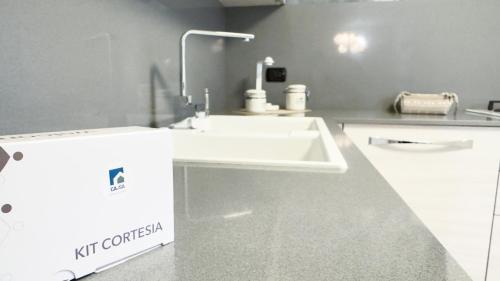 a kitchen with a white sink and a counter at Lady Teresa Apartment by Ca-Sa Check in Chioggia