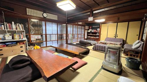 a living room with a couch and a table at Hostel Murasaki in Takayama