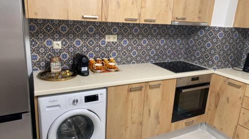 a kitchen with a washing machine and a stove at Enna House 2 in Athens
