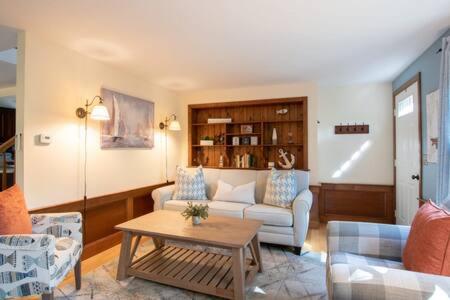 a living room with a couch and a table at Bring your pups to Chatham Direct access to the Cape Cod Rail Trail in Chatham