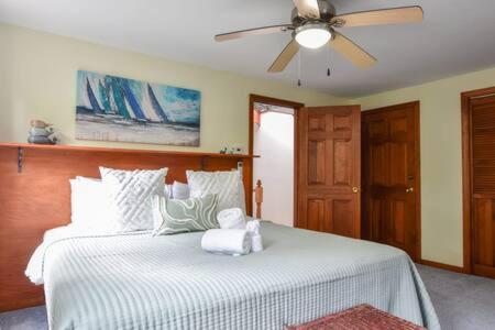 a bedroom with a bed with a teddy bear on it at Bring your pups to Chatham Direct access to the Cape Cod Rail Trail in Chatham