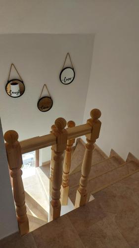 a staircase with three signs on the wall and a stair railing at Casa Iarina Rânca in Ranca
