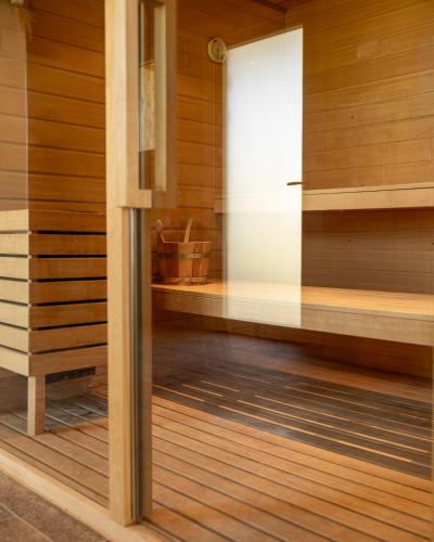 a room with wooden flooring and a glass wall at Hotel rural Finca Vivaldi Nature & Spa in San Miguel de las Dueñas