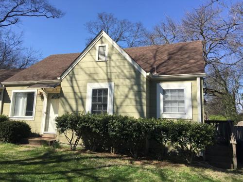 a yellow house with a brown roof at Hangout House play, work, and visit in Nashville