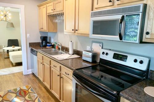 a kitchen with a stove and a microwave at Hangout House play, work, and visit in Nashville