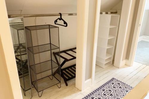 a room with a shelf and a chair in it at Hangout House play, work, and visit in Nashville