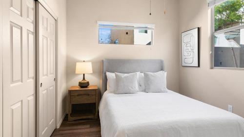 a bedroom with a bed and a lamp on a night stand at Landing Modern Apartment with Amazing Amenities (ID8267X35) in Tucson