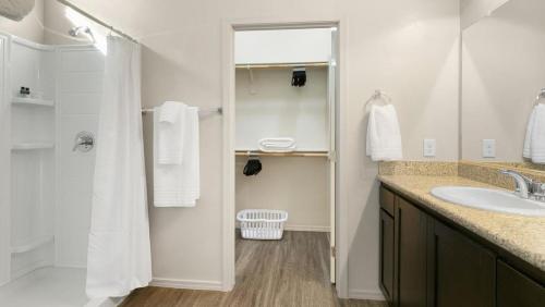 a white bathroom with a sink and a shower at Landing Modern Apartment with Amazing Amenities (ID8267X35) in Tucson